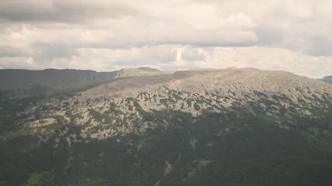 The camera in a light-engine plane flies in the mountains. 動画素材 119995685