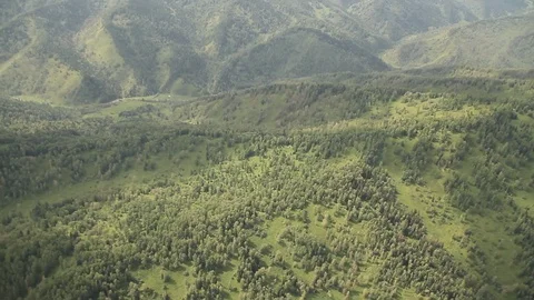 The camera in a light-engine plane flies in the mountains. 動画素材 119995734