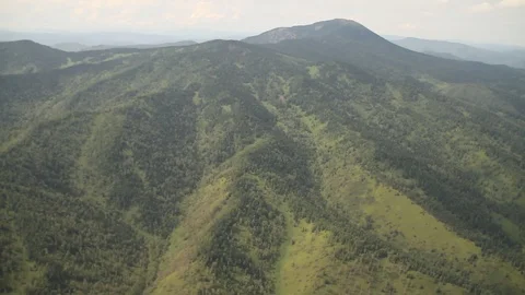 The camera in a light-engine plane flies in the mountains. 動画素材 119995735