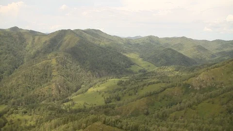 The camera in a light-engine plane flies in the mountains. 動画素材 119995766