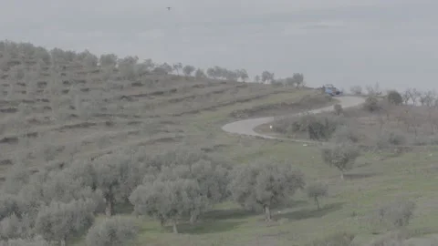 Camera at long distance from the moving tractor 스톡 동영상 154662554