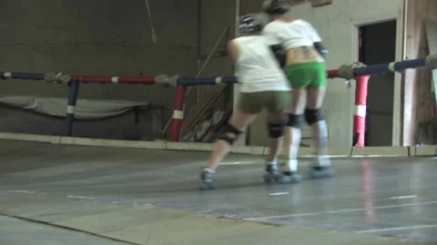 Camera long-lens of skaters going around banked track, Texas Roller Derby Video stock 232957902