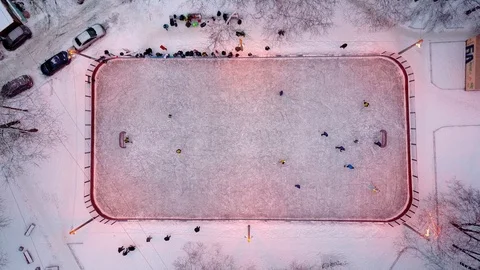 Camera look down to ice hockey arena from height, young team bustle near goal Stock Footage 85510399