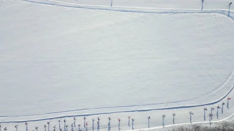 The camera looking down flies up over the turn of the ski track Stock Footage 233156173