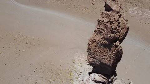 Camera looking down on tall column of rock at La Pacana Caldera Atacama dese Stock Footage 265864218