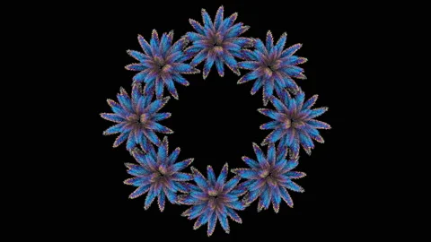 The camera looks down at a wreath of abstract neon palm trees on a black Stock Footage 125950373