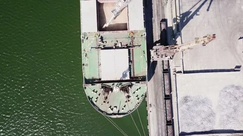 The camera looks vertically downward as it flies over a seagoing vessel moored i Stock Footage 155797835