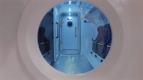 The camera looks into the window of a multi-seat hyperbaric chamber. Stock Footage 247244075