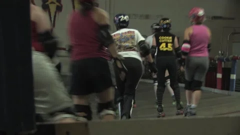 Camera low angle of skaters training, Texas Roller Derby Stock Footage 232957995