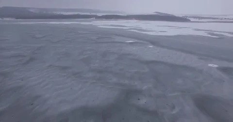 Camera low over the frozen lake, aerial photography Stock Footage 83567157