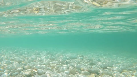 The camera is lowered under clean seawater. Stone bottom. Rest at the sea. Warm Video stock 157037231