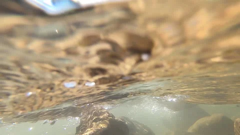 Camera is lowered under clean transparent water of mountain river. Stock Footage 171868482