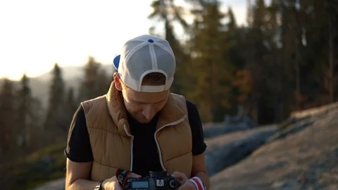 Camera man looking over mountains and hill tops through binoculars, California Stock Footage 98569848