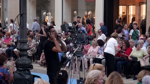 Camera man on the phone getting ready before the beginning of a show Stock Footage 116640830