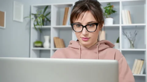 The camera in motion shoots a portrait of a young woman in glasses working  Stock Footage 149006894