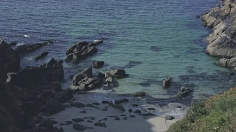 The camera motion is tilted. Overlooks the ocean with clear blue water and a Stock Footage 229506048