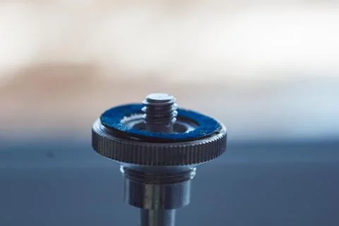 Camera mount with screw-thread close-up on a blurred background. instrument f Stock Photos