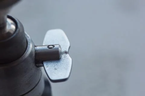 Camera mount with screw-thread close-up on a blurred background. instrument f Stock Photos