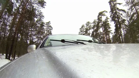 Camera mounted on a car when moving on winter road in forest. It goes sleet Stock Footage 71768604