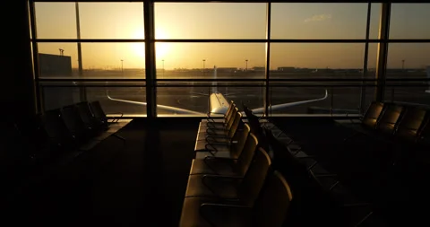 Camera move along empty seats at boarding gate, parked airliner outside Stock Footage 303325864