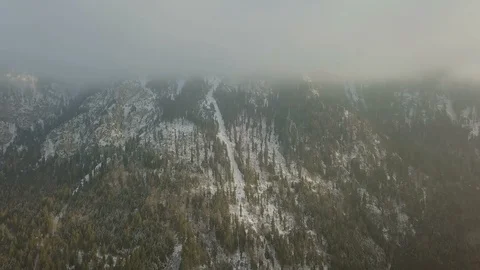 Camera move up in the clouds that covered mountain aerial footage Stock Footage 86139158