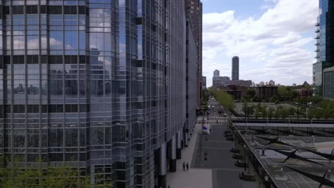 Camera move right through the glass tower and open view to urban park Stock Footage 240687278