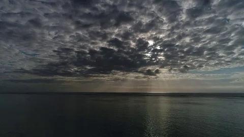 Camera move up view on the sunset in the ocean. Clouds in the sky. Video stock 84805248