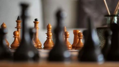 Camera movement along a chessboard with white pieces in focus. Board strategy Stock Footage 244057040