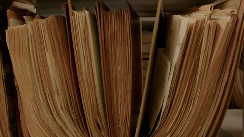 Camera movement along a file shelf. The paper of the files is old. Stock-Footage 95426161