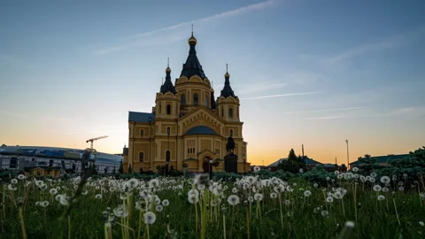 Camera movement among dandelions with the image of the Alexander Nevsky Stock Footage 276961561