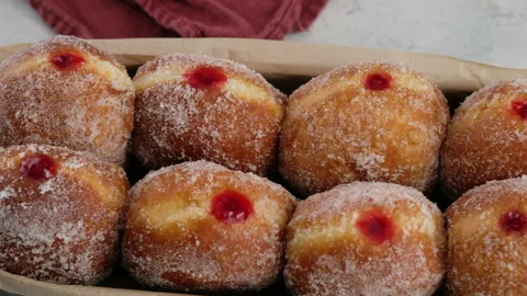 Camera movement. Berliners. Donuts with raspberry jam lie on a serving tray on a Video stock 152485278