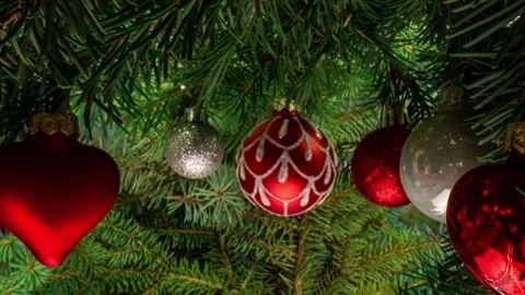 Camera movement between branches and Christmas tree decorations. Christmas Stock Footage 221724779