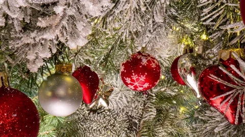Camera movement between branches and Christmas tree decorations. Christmas Stock Footage 221734391