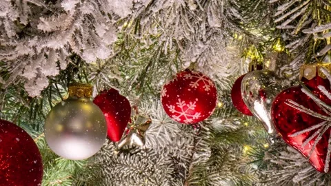 Camera movement between branches and Christmas tree decorations. Christmas Stock Footage 223388079