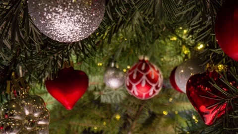 Camera movement between branches and Christmas tree decorations. Christmas Stock Footage 223389494