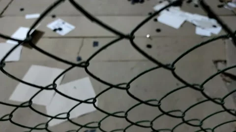Camera movement from bottom to top along the metal mesh chain-link. Stock Footage 198391375