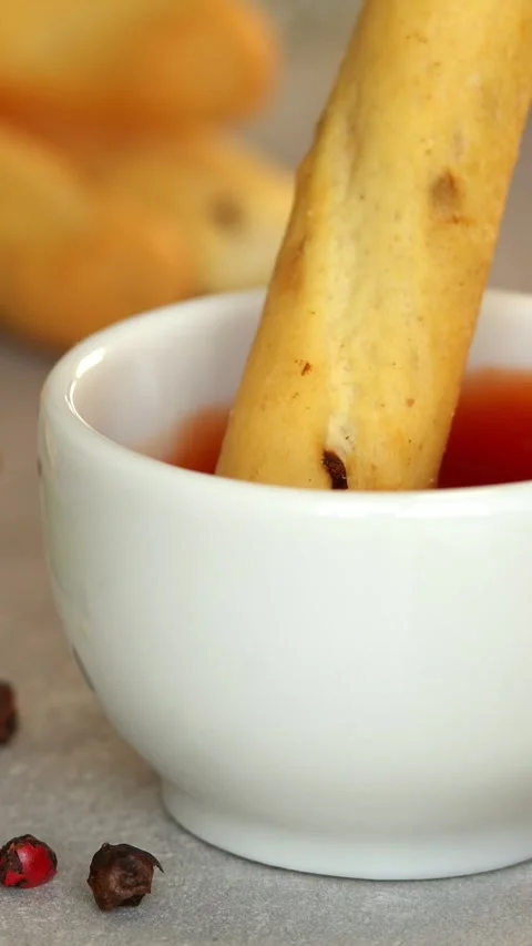 Camera movement on bread stick dips in ketchup sauce. Toast crouton. Food Stock Footage 321796504