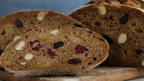 Camera movement. Close up. Beautiful rustic rye bread lies on a wooden board Stock Footage 147031171