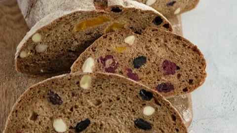 Camera movement. Close up. Beautiful rustic rye bread lies on a wooden board Stock Footage 148573413