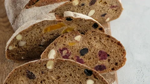 Camera movement. Close up. Beautiful rustic rye bread lies on a wooden board Stock Footage 152487166