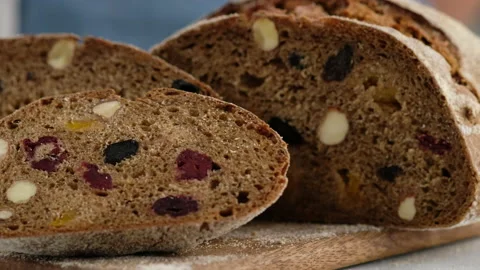 Camera movement. Close up. Beautiful rustic rye bread lies on a wooden board Stock Footage 152487460