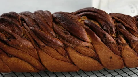 Camera movement. A close-up bun with cinnamon and chocolate lies on the wire Stock Footage 145546595