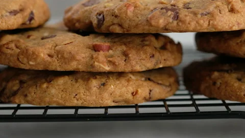 Camera movement. Close-up of a chocolate chip cookie lies on the wire rack. A Stock Footage 145545527