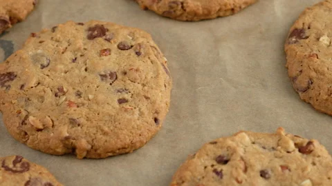 Camera movement. Close-up of a chocolate chip cookie lies on a baking sheet. A Video stock 147050202