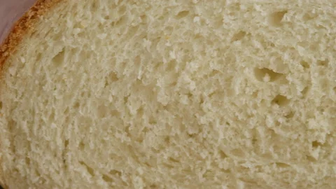 Camera movement. Close-up of hot wheat bread lies on a lattice on a light table Stock Footage 146154636