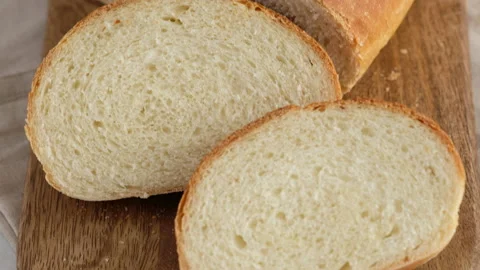 Camera movement. Close-up of hot wheat bread lies on a lattice on a light table Stock Footage 148571651