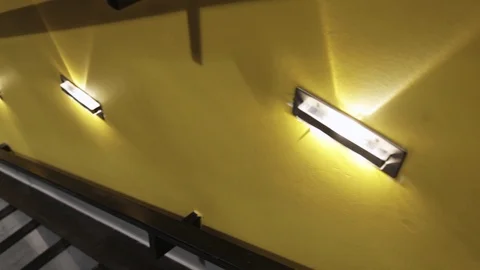 Camera movement down the loft stairs in a modern interior around yellow walls Stock Footage 111812272
