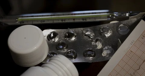 Camera movement from empty tablet package to electrocardiogram Stock Footage 116795351