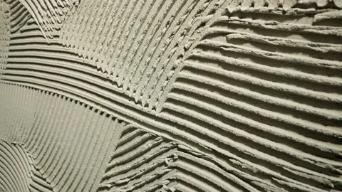 Camera movement by fresh concrete tehture with patterns of notched trowel. Macro Stock Footage 227571171