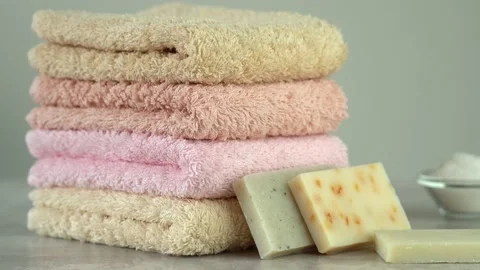 Camera movement on fresh stacked cotton terry towels with soap and sea salt 스톡 동영상 211395788